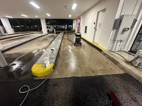 Bank drive-thru lane washed clean, with a fresh yellow curb island